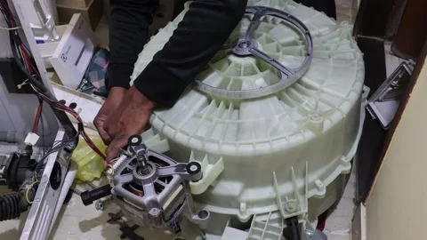 Washing machine repairing by a working professional expert man. Stock Footage 228398014
