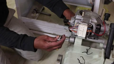 Washing machine repairing by a working professional expert man. Stock Footage 228398052