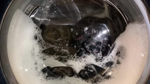 The washing machine rotates the drum in one direction or the other, taking short Stock Footage 150312789