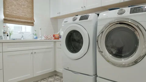 Washing Machine Running in an Empty White Laundry Room Stock Footage 155867062