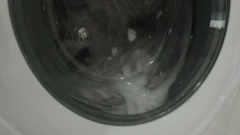 Washing Machine Running in an Empty White Laundry Room Stock Footage 155867967
