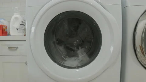 Washing Machine Running in an Empty White Laundry Room Stock Footage 155868157