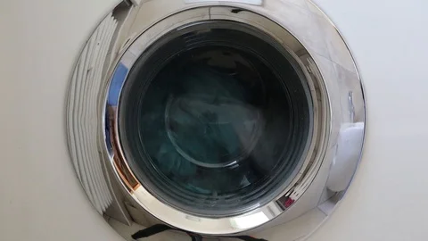Washing machine is running the program to wash the bed sheets in the Stock Footage 117463598