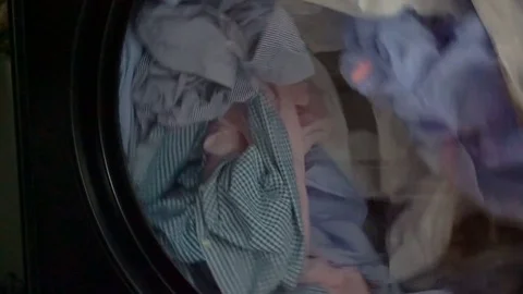 Washing machine with shirts inside Stock Footage 76860453