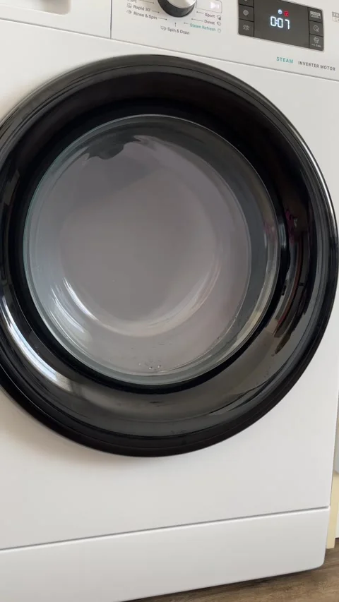 Washing Machine Spinning Clothes During Laundry Cycle Stock Footage 303189431