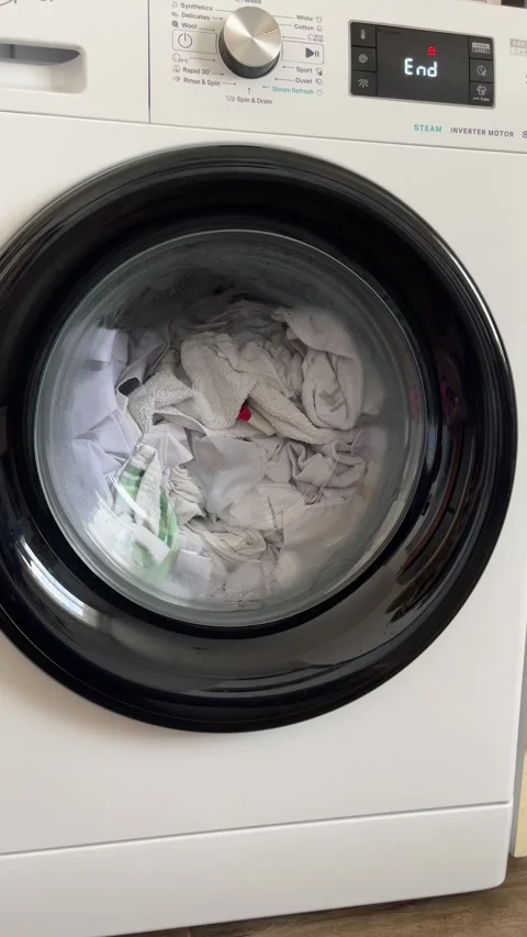 Washing Machine Spinning Clothes During Laundry Cycle Stock Footage 303189466