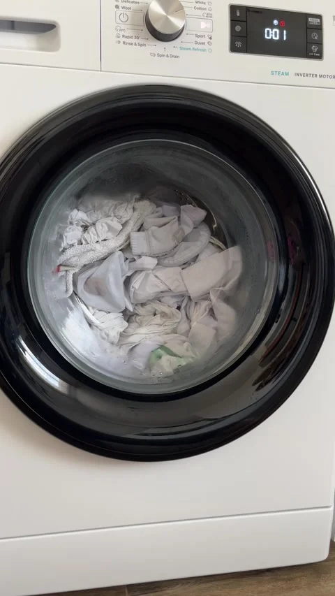 Washing Machine Spinning Clothes During Laundry Cycle Stock Footage 303189481