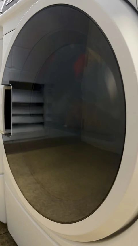 Washing machine spinning clothes during an active laundry cycle Stock-Footage 342977896