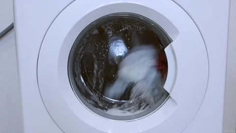 The washing machine is spinning the laundry in the drum Stock Footage 151411815