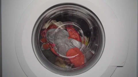 Washing machine with stuffed animals- 100FPS Slow clockwise rotation and stop Stock Footage 153278247
