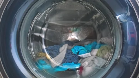 The washing machine washes dirty colored clothes. Stock Footage 242608928