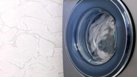 The washing machine washes dirty colored clothes. Stock-Footage 242608932