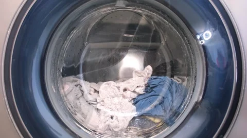 The washing machine washes dirty colored clothes. Stock Footage 246627608