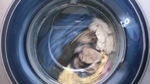 The washing machine washes dirty colored clothes. Stock-Footage 255124949