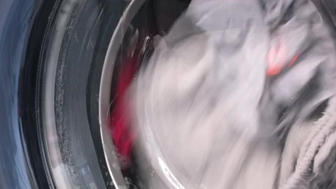The washing machine washes dirty colored clothes. Stock Footage 255125000
