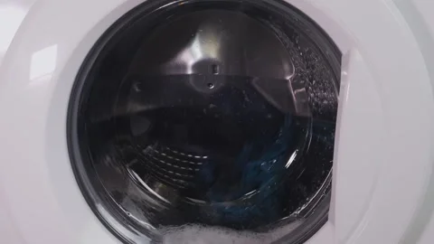 The washing machine is washing clothes, the drum is spinning Stock Footage 326222875