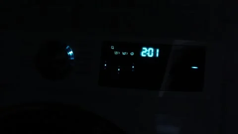 Washing machine. Washing machine timer switched on. Glowing numbers in the dark. Stock Footage 293289706