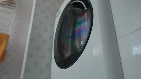 Washing machine working in the bathroom against the window Stock Footage 305410900
