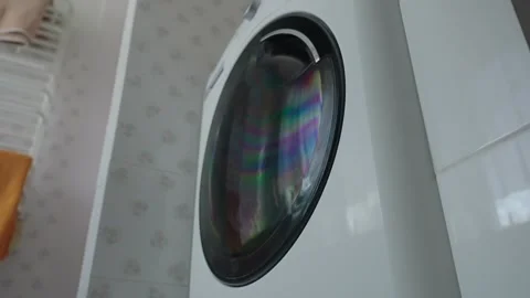 Washing machine working in the bathroom against the window Stock Footage 306931825