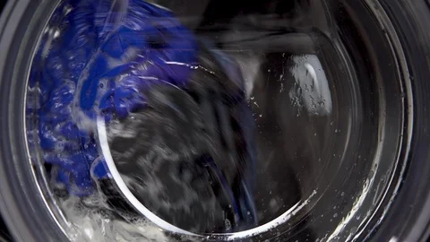 The washing machine is working. A washing machine spins a drum filled with Stock Footage 125914116