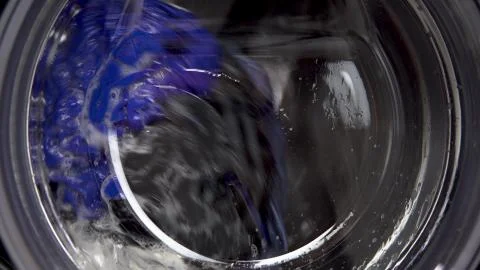 The washing machine is working. A washing machine spins a drum filled with Stock Photos