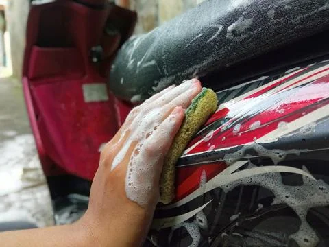 Washing a Motorcycle by Hand Using a Sponge and Soap Foam Stock Photos