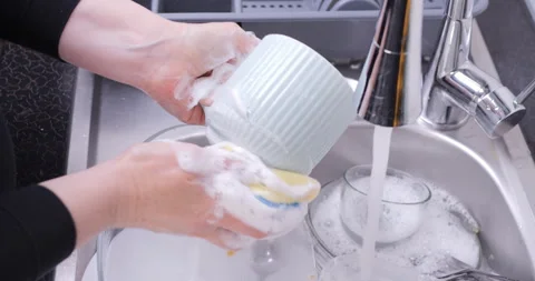 Washing a Mug by Hand in Kitchen Sink Stock Footage 327544366