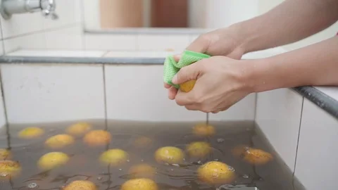 Washing oranges before eating Stock Footage 100875834