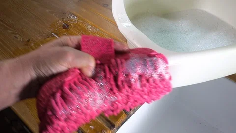 Washing a pine sink worktop / countertop with a pink sponge. Stock Footage 114887986