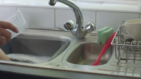 Washing Up A Plastic Tupperware Box Stock Footage 95681573