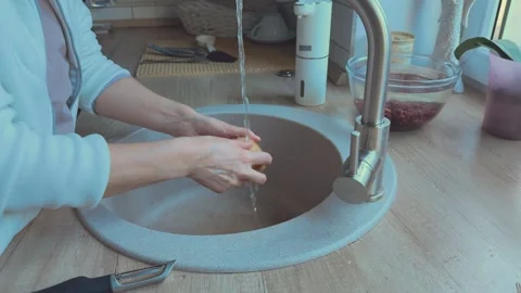 Washing potatoes under running water in kitchen sink, Concept of food hygiene Video stock 341985677