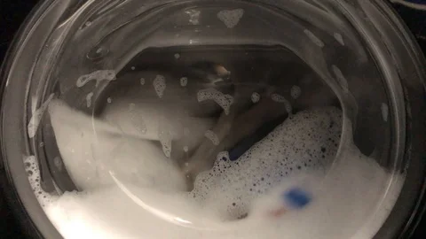 The washing process in the black washing machine. Video stock 122303156