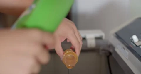 Washing process.Liquid detergent poured into the drum in the amount of 2 full ca Stock Footage 223901691