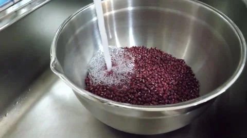 Washing Raw Adzuki Red Beans with Running Water in Stainless Steel Bowl Stock Footage 345292302