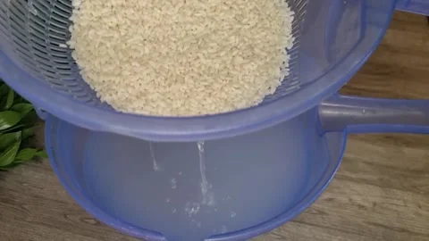 Washing Rice and Draining Starchy Water | Kitchen Food Preparation 4K Stock Footage 344938394