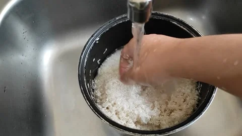 Washing rice before cook Stock Footage 165081872