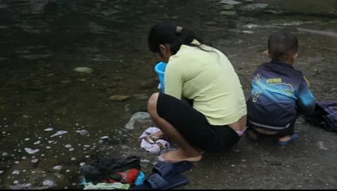 Washing at the river 스톡 동영상 10564868