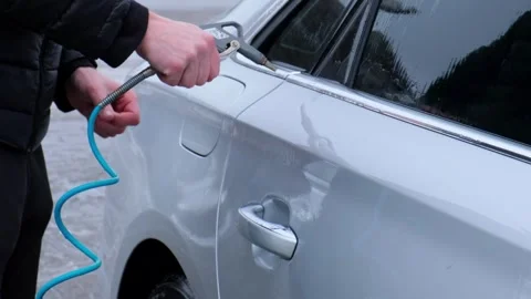 Washing silver car on touchless car wash self-service and high pressure Stock Footage 250595853