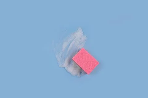 Washing Sponge lying on surface in soapy foam Stock Photos
