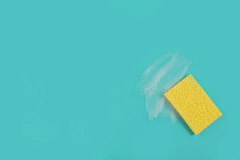 Washing Sponge lying on surface in soapy foam Stock Photos