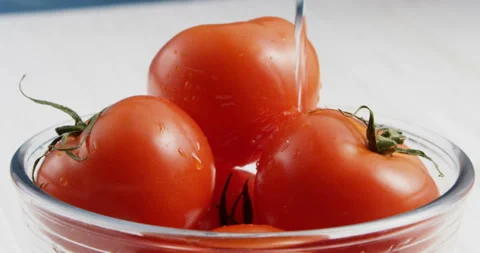 Of washing tomatoes in bowl Stock Footage 100548832