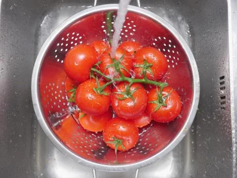Washing tomatoes Stock Photos