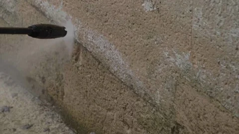 Washing wall in slow motion with high pressure jet water spray and cleaning h Stock Footage 157007312