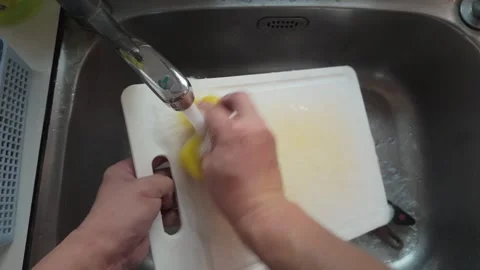 Washing White Plastic Cutting Board in Kitchen Sink Stock Footage 346302768
