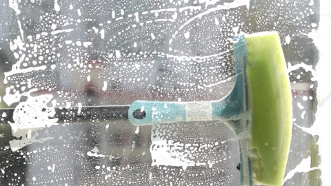 Washing the window with cleaning agent in the apartment Stock Footage 243038055