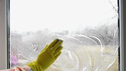 Washing the window with a foam sponge. Cleaning the house. Stock Footage 152455508