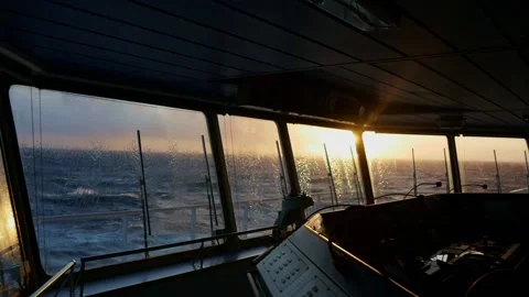 Washing windows on the navigation bridge at sunset Stock Footage 135882873