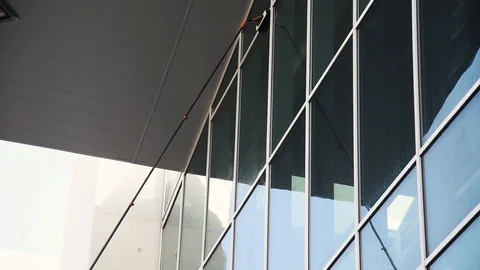 Washing windows with telescopic pole Stock Footage 129255723