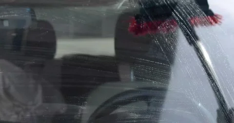 Washing the windshield with a squeegee at a gas station. Comfort and good vi Stock Footage 342182669