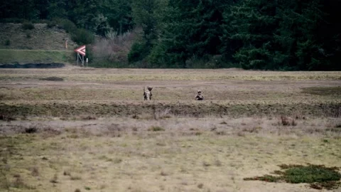 WASHINGTON - 1.14.2026 - Distant view of US Army soldiers running across a Stock Footage 337719743